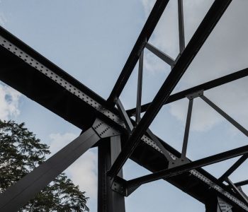 black metal bridge under blue sky during daytime